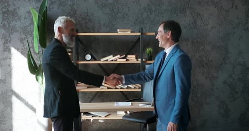 Two Business Men Shake Hands When Meeting at Office Agree to a Deal or Say Hello