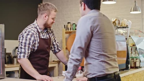 Barista Serving Customer in Coffee Shop