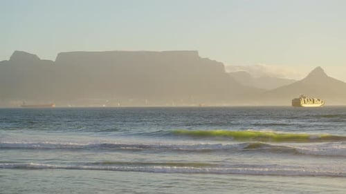 Beautiful Clear Day Looking To Table Mountain and Mother City with Ocean Waves Crashing Over Rocky