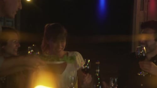 Friends Sharing Food and Drink at Night