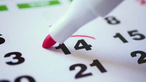 Marking Date on Calendar with a Red Marker