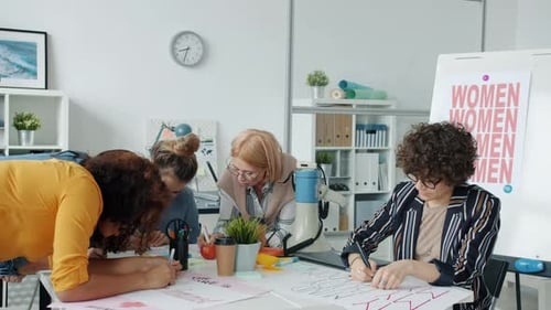 Group of Independent Women Drawing Posters for Gender Equality Protest