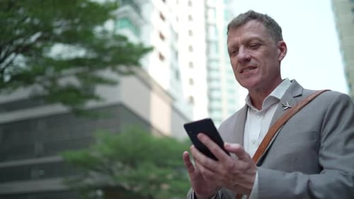 Man Using Smartphone in Urban Setting