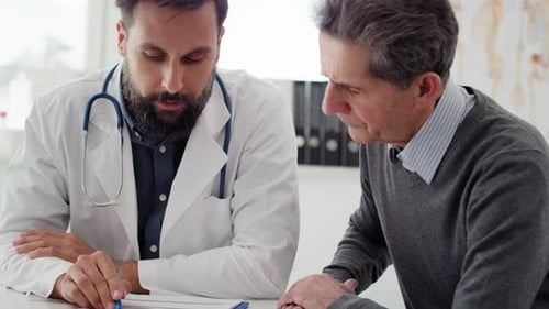 Doctor Consults with Senior Male Patient in Office