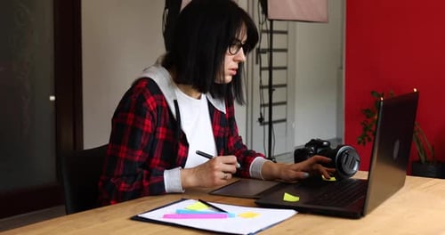 Woman Working on Graphics Tablet at Desk