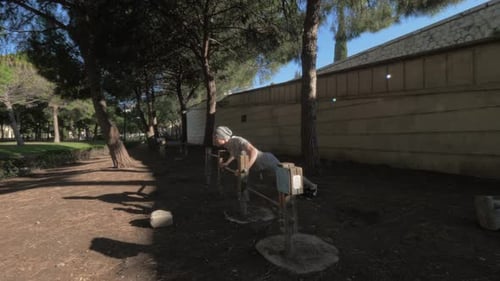 Man Doing Push-Ups in Urban Park Exercise Area