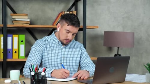 Thoughtful businessman writes in notebook thinks solution problem performance