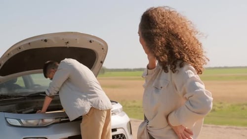 Woman Calls for Help While Man Inspects Car