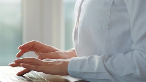 Woman Typing on Laptop Keyboard Close Up