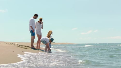 Young family spending time on beach
