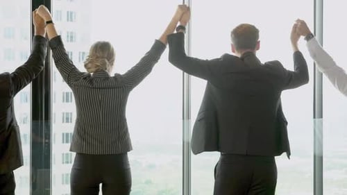 Office Workers Raise Arms in Corporate Celebration