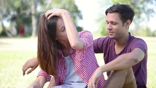 Affectionate Couple Relaxing Together in Grassy Park