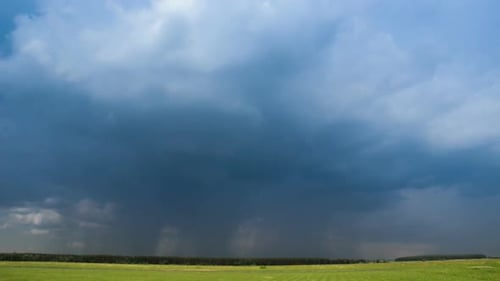 Ominous Storm Cloud System Over Green Landscape