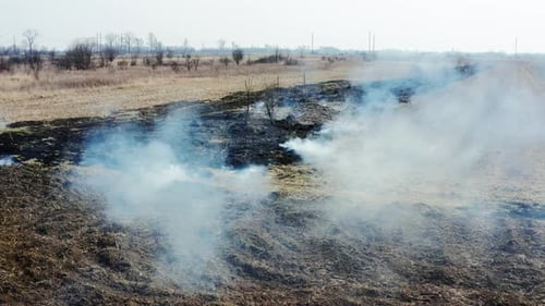 Smoke rising from scorched rural countryside after fire