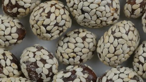 Close Up of Brown Candies Covered with Sesame Seeds