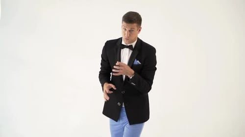 un divertido showman con chaqueta negra muestra cómo un trompetista toca una trompeta en un concierto