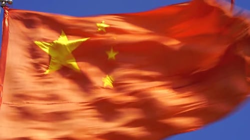 China's Flag Waving in the Wind Close Up