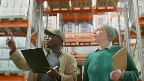 Diverse Warehouse Managers Doing Inventory Together