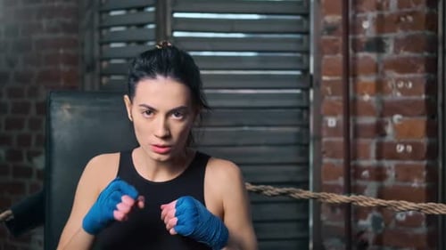 Woman Practicing Boxing Punches in Ring