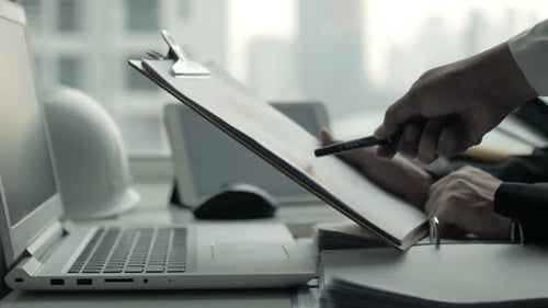 Office Workers Reviewing Documents in Meeting