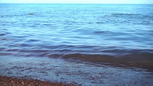 Sea Waves Roll On The Pebble Beach