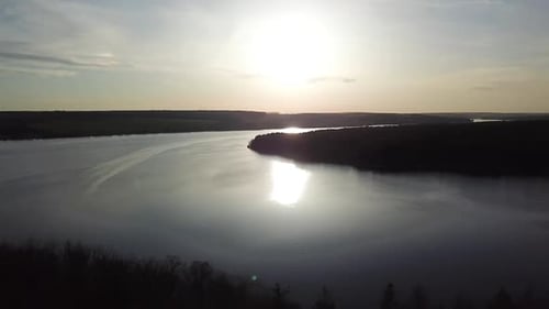 Aerial View. Beautiful sunset over the lake and pine forest. Beautiful nature river