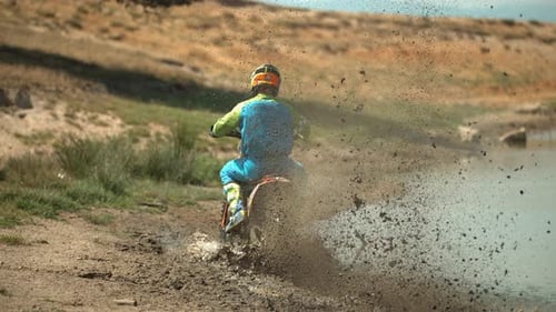 Motocross Rider Powers Through Mud on Dirt Bike