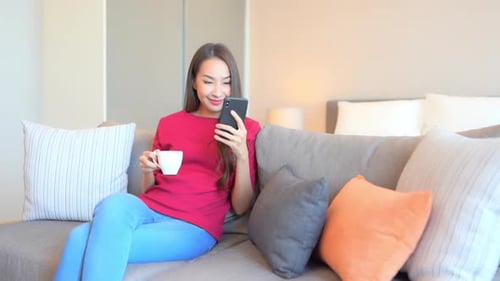 Woman Relaxing on Couch and Looking at Phone