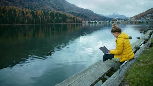 Woman Work on Laptop Next to Mountain Lake