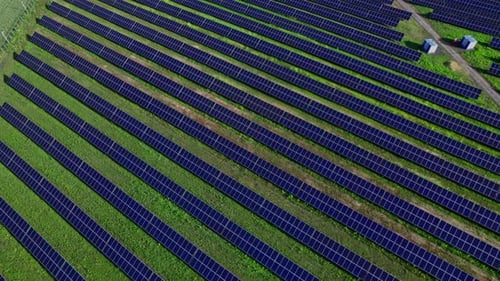 Aerial View of Solar Panels Stand in a Row in the Fields