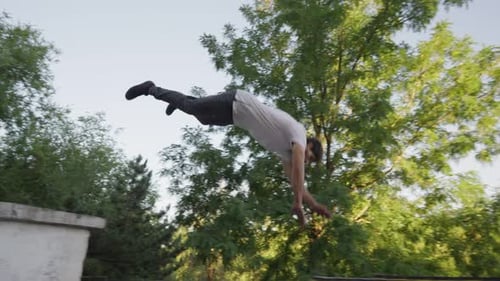 Man Performing Parkour in Urban Park Setting