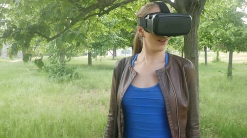 Woman Exploring Virtual Reality World in the Park