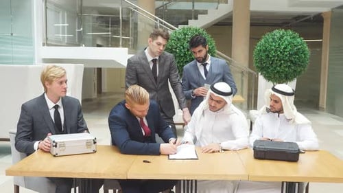 International Business Men Signing a Contract