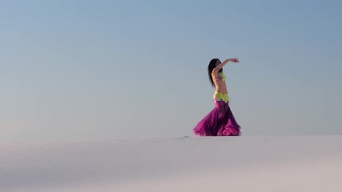 Girl Dances Belly Dancing in the Sandy Desert, Her Movements Are Unique