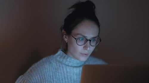 Woman With Laptop Working Late at Night