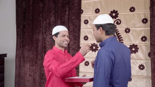 Muslim men giving gift on Eid
