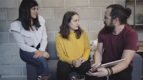 People Discussing Work on Tablet in Office Environment