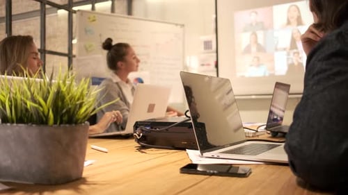 Video call teleconference meeting in a business office with partner team.