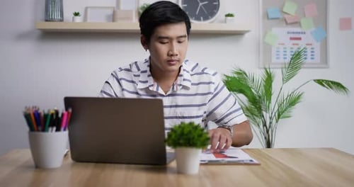 Portrait of Happy asian businessman with laptop computer working at home office