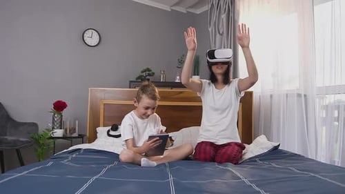 Woman Using VR Headset While Boy Uses Tablet