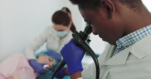 Doctor Using Endoscope to Examine Patient in Hospital