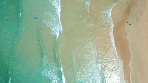 Aerial View To Tropical Sandy Beach and Blue Ocean. Top View of Ocean Waves Reaching Shore on Sunny