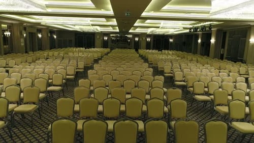 Empty Auditorium with Rows of Chairs and Podium