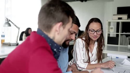 Business People Meeting at Table in Office and Talking