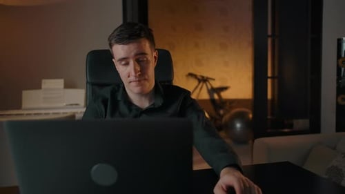 Young Adult Video Conferencing at Home at Night