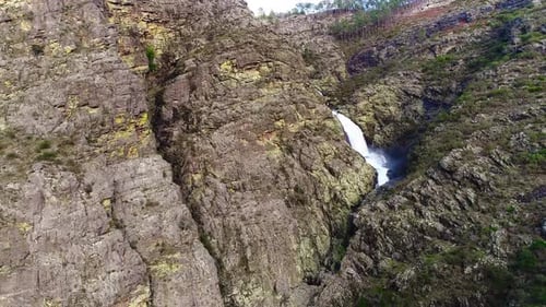 Majestic Waterfall Cascading Down Rugged Rocky Terrain