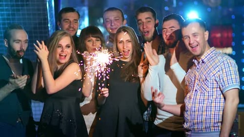 Friends are Holding Sparklers and Dancing Together