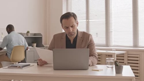 Caucasian Businessman Working at Desk