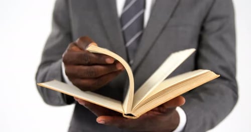 Businessman flipping pages of a book