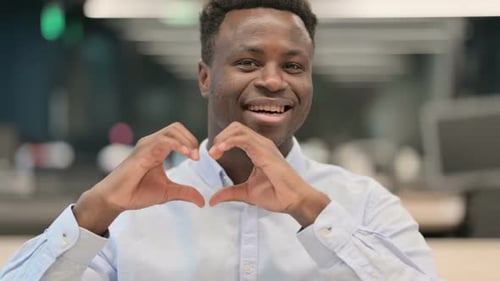 Young Adult Making Heart Shape Gesture